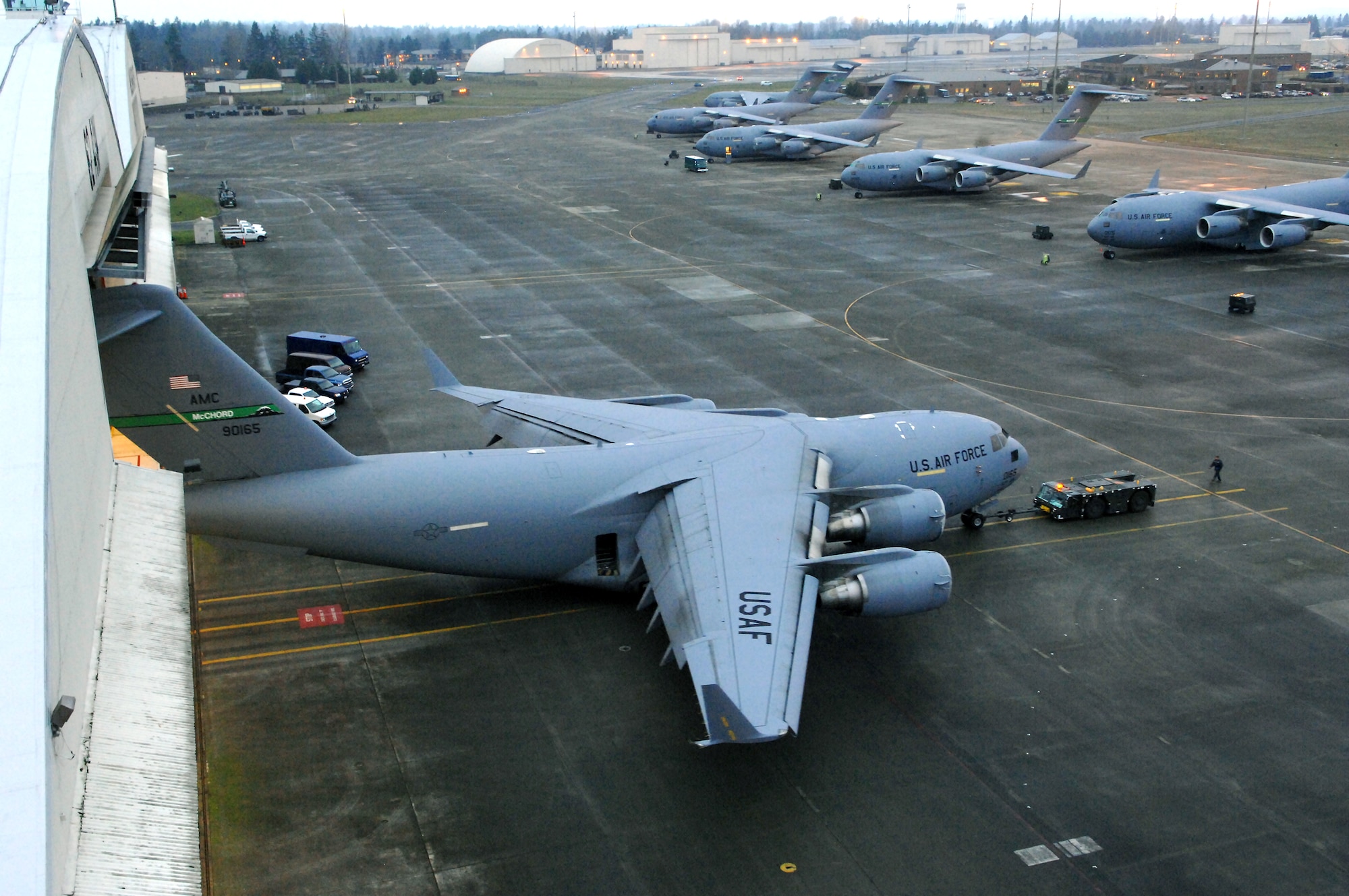 A C-17 Globemaster III is towed into a hangar using an MB-2 aircraft tow tractor Jan. 26 for a home station inspection at McChord Air Force Base, Wash. Airmen from McChord AFB provide airlift and aeromedical evacuation in support of the war on terrorism and other contingencies around the world. (U.S. Air Force photo/Abner Guzman)
