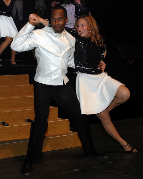 Technical Sergeant Kenneth Bruce Jr., NCOIC DGS-5 Stan/Eval from Hickman AFB, Hawaii, and 1st Lt. Carolynn Czepiga, protocol officer from Tyndall AFB, Fla.,  perform for the City of Abilene and Dyess AFB during the Tops in Blue concert January 23. The concert is performed all over the world including deployed locations. (U.S. Air Force photo by Senior Airman Courtney Garrard)