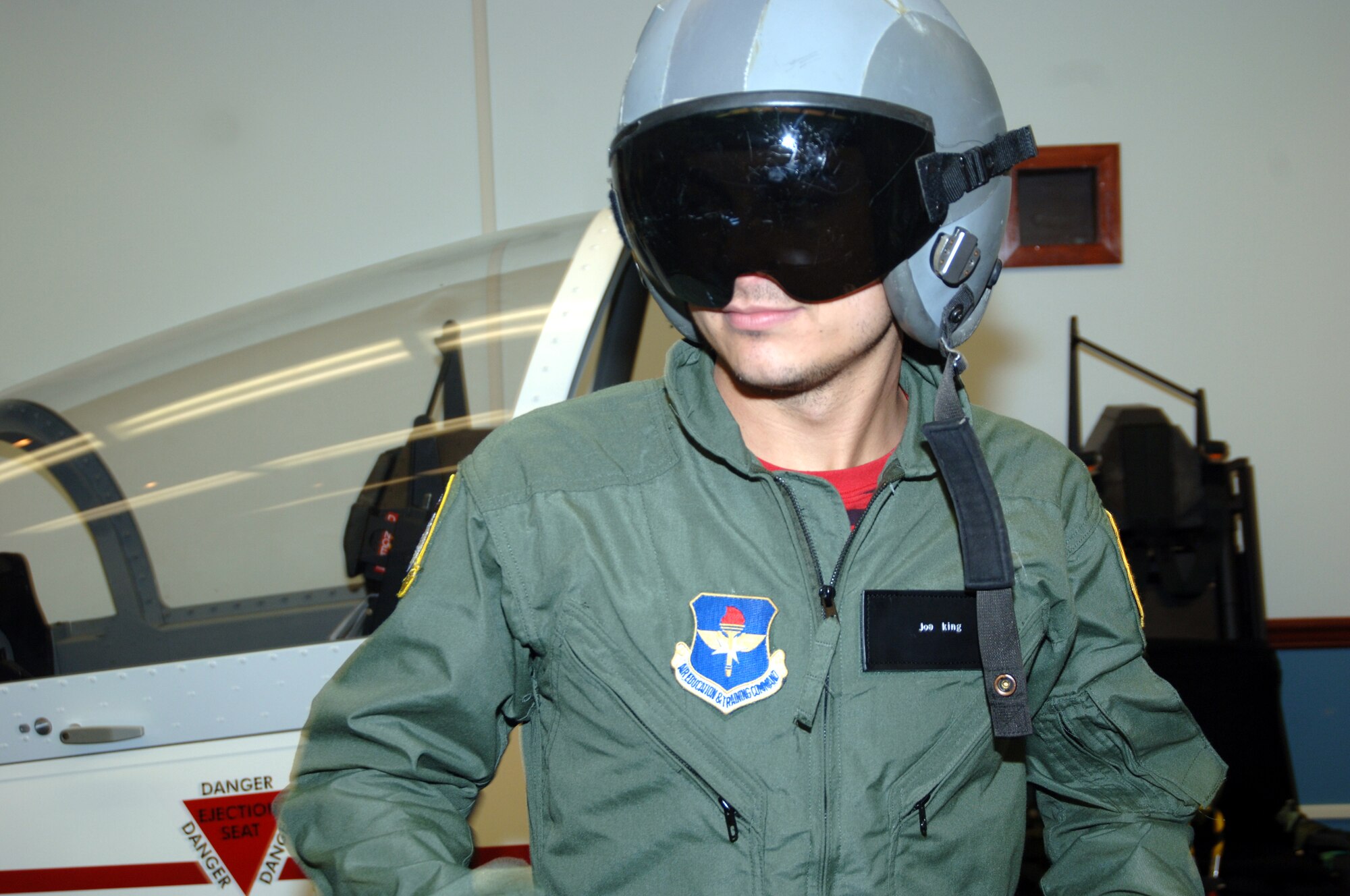 Joe King, The Fray guitarist, sports his flight suit and helmet during T-37 egress training prior to his orientation flight Tuesday at Columbus Air Force Base. Band members received a wing mission briefing and had lunch with CAFB members before their flights. (Photo by Senior Airman John Parie)