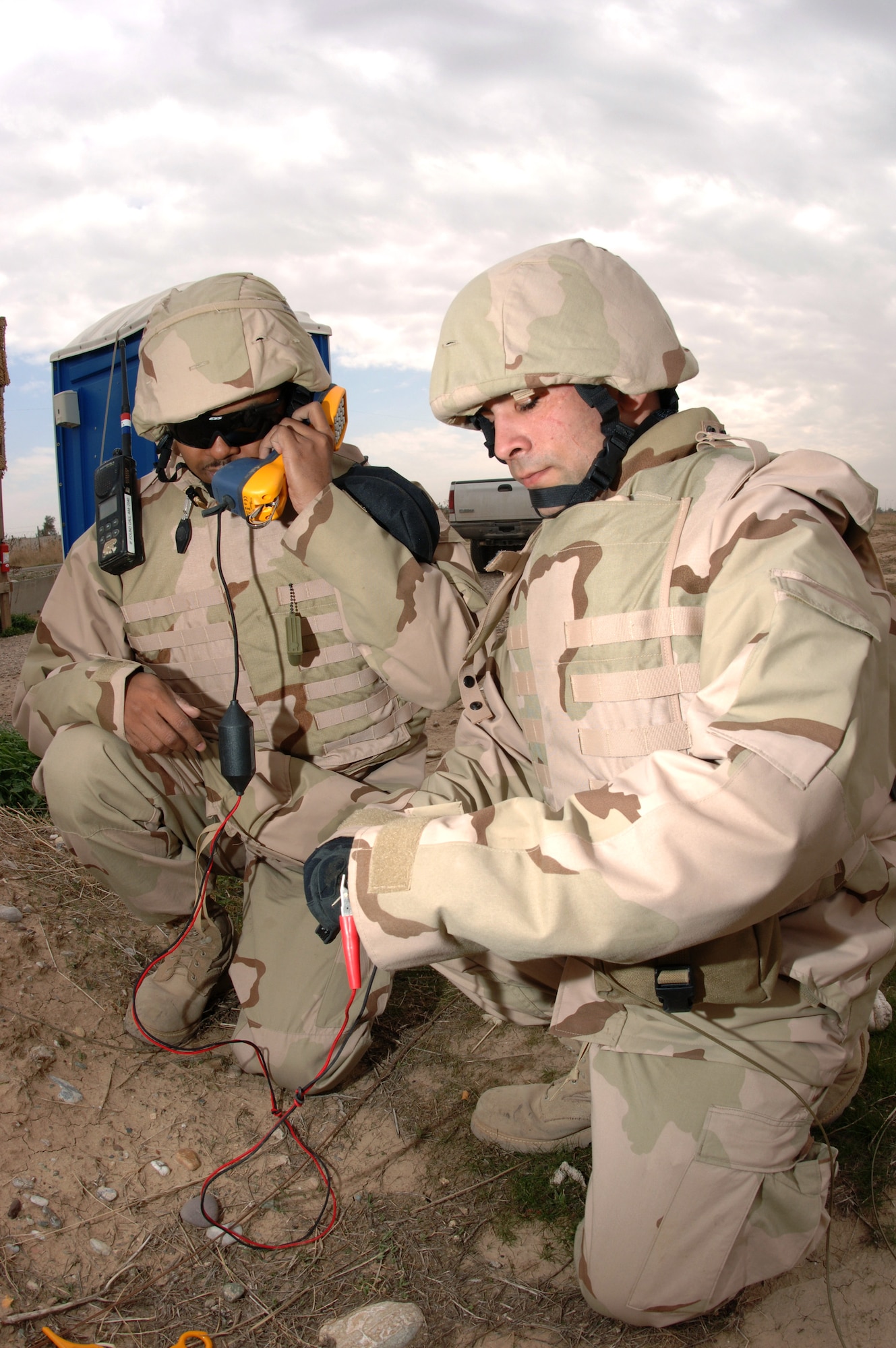 Senior Airman Kenneth Hawkins and Airman 1st Class Ryan Gall tests cutfield wires for a dial tone Jan. 30 at Kirkuk Regional Air Base, Iraq. By providing communications to security forces watch towers, voice systems technicians assist with base security. Both Airmen are voice systems technicians assigned to the 506th Expeditionary Communications Squadron. (U.S. Air Force photo/Senior Airman Bradley A. Lail) 