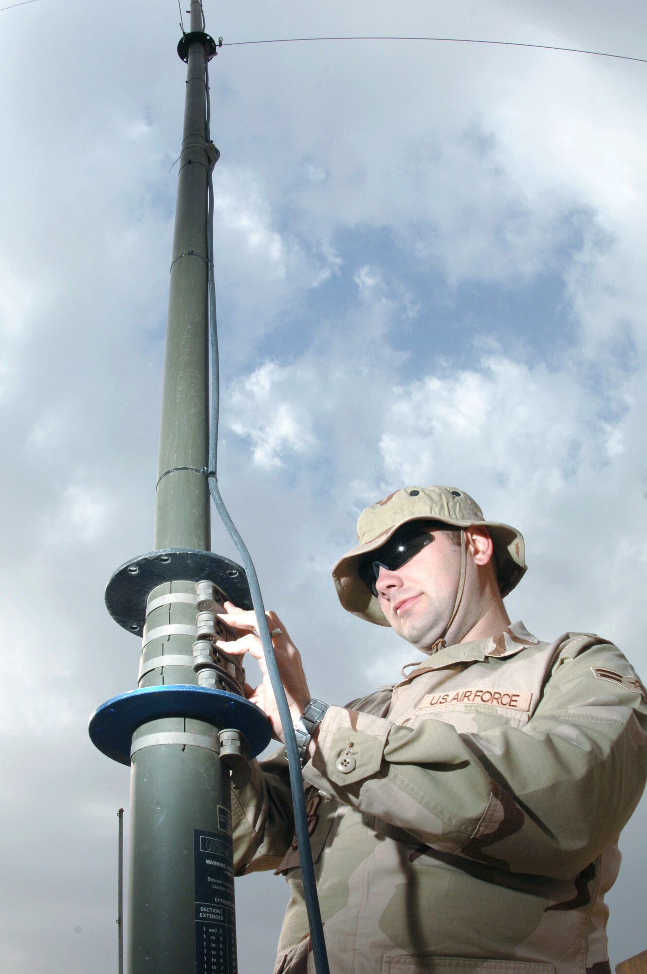 Airman 1st Class Benjamin Murphy stands up an antenna mast pole Jan. 30 at Kirkuk Regional Air Base, Iraq. The mast pole is used to elevate antennas as high as possible for longer radio transmitions. Airman Murphy is a ground radio technician assigned to the 506th Expedtionary Communications Squadron. (U.S. Air Force photo/Senior Airman Bradley A. Lail)
