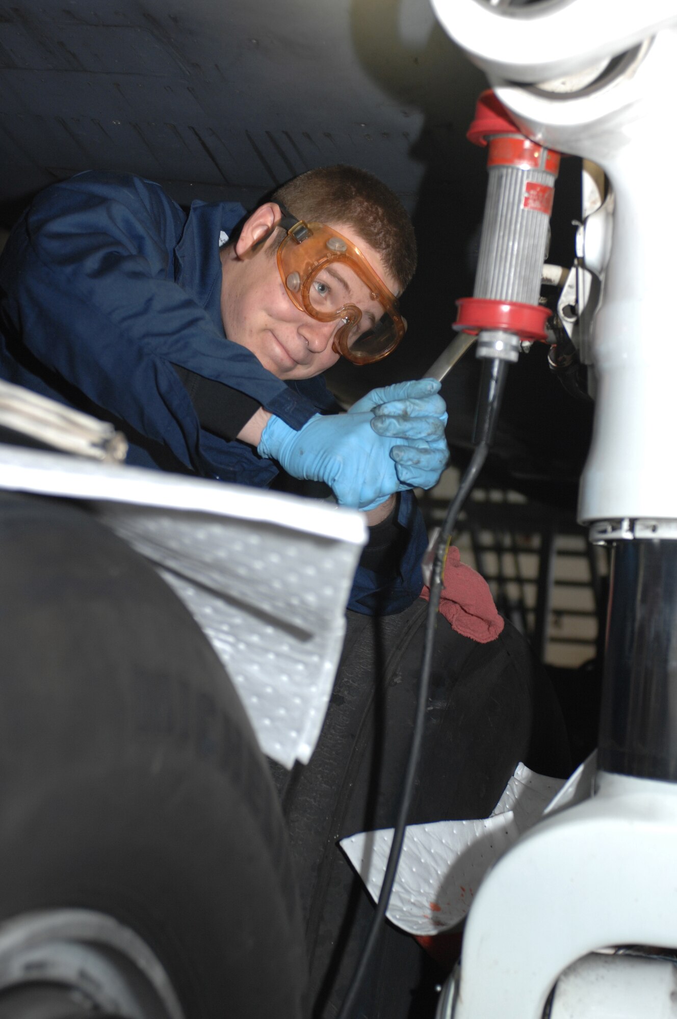 Senior Airman Brian Muller, 7th Component Maintenance Squadron, loosens a nut around a hydraulic line located on a B-1 Lancer. The CMS Hydro shop works on all hydraulic systems located on a B-1 or a C-130. (U.S. Air Force photo by Airman Jennifer Romig)