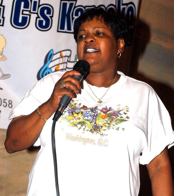 Laura L. Horner sings a karaoke song during a benefit at American Legion Post 162 in Lorton, Va., to raise money for wounded servicemembers being treated at Landstuhl (Germany) Regional Medical Center. Photo by Rudi Williams