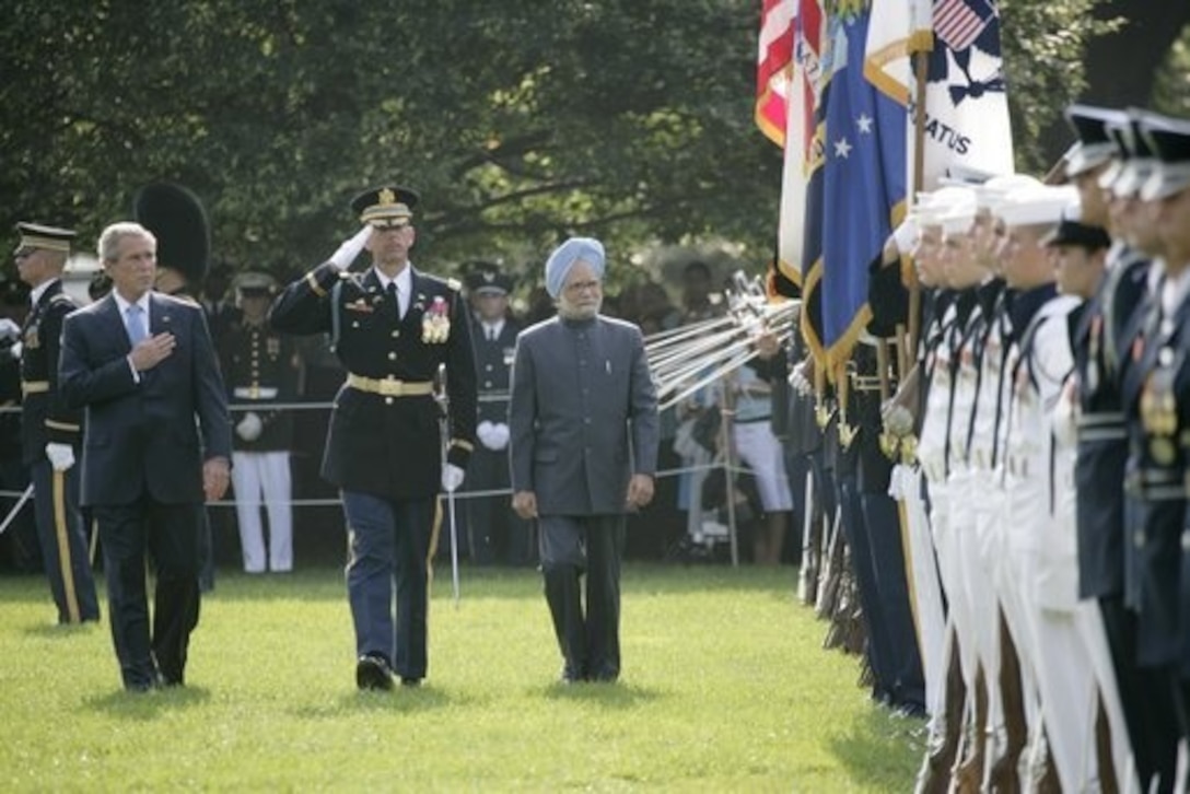 President Bush reviews an honor guard with India's Prime Minister Dr. Manmohan Singh on July 18 on the South Lawn of the White House during Singh's official arrival ceremony. Photo by Eric Draper