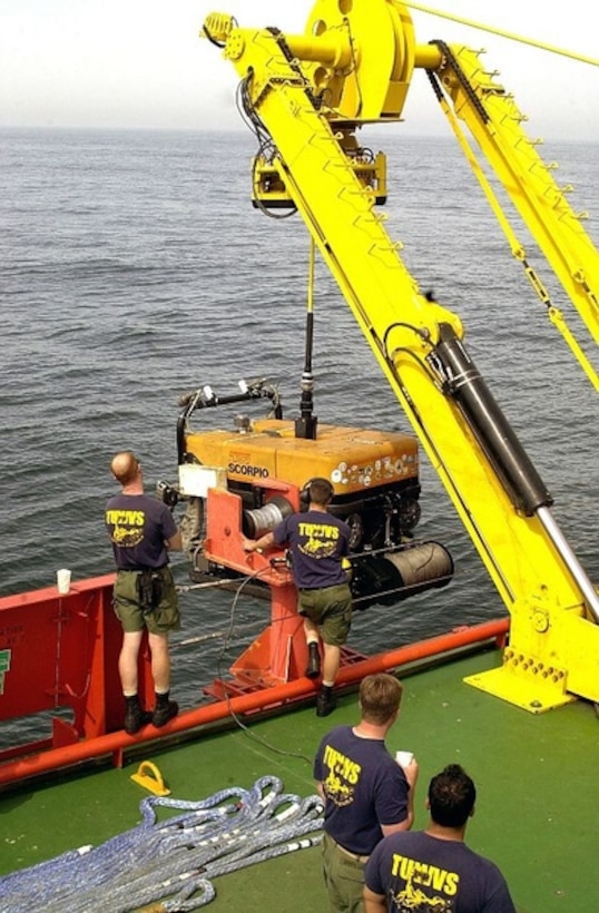 Personnel from the U.S. Navy's Deep Submergence Unit Unmanned Vehicle Detachment guide a "Super Scorpio" remotely operated vehicle to a safe recovery aboard the special mission charter ship M/V Kellie Chouest April 26, 2004. The Super Scorpio was being used to survey wreckage of an F-14D Tomcat that crashed off the coast of Point Loma, Calif. Photo by Petty Officer 1st Class Daniel N. Woods, USN