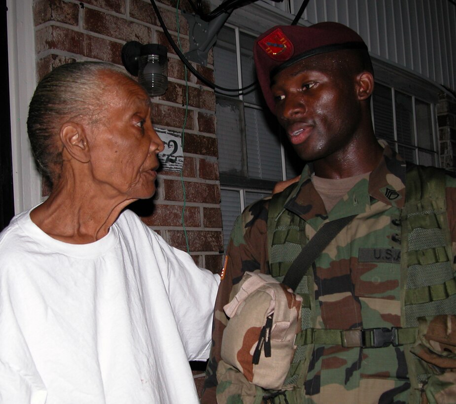New Orleans resident Alexcener Reaux, 74, thanks Army Staff Sgt. Samuel H. Zoker, a 29-year-old 82nd Airborne Division paratrooper, from Trenton, N.J., outside her home in Algiers, an old neighborhood in New Orleans Sept. 17. Zoker's unit, Battery A, 2nd Battalion, 319th Airborne Field Artillery Regiment, has been conducting neighborhood patrols through Algiers since Sept. 15. Photo by Gerry J. Gilmore