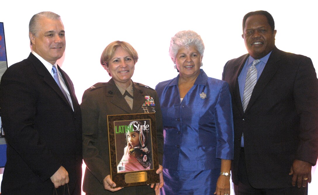 Col. Angela Salinas, second from left, is this year's Latina Style magazine's outstanding Marine Corps Hispanic woman award recipient. To her left is Robert E. Bard, president and chief executive officer of Latina Style magazine. To her right is Rep. Grace Napolitano, chairwoman of the Congressional Hispanic Caucus, and Clarence Johnson, principal director, Office of the Deputy Undersecretary of Defense for Equal Opportunity. Photo by Rudi Williams