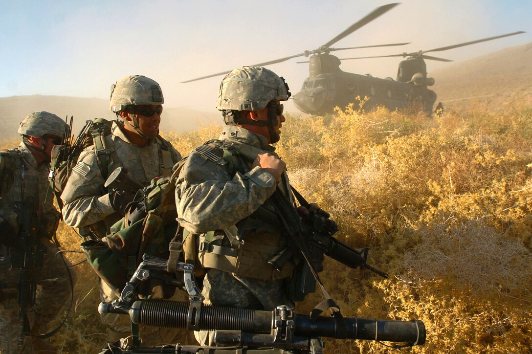 Paratroopers from Company A, 1st Battalion, 325th Airborne Infantry Regiment, prepare to board a Chinook transport helicopter that will return them to their home base at the end of a five-day mission in Mianashin, Afghanistan, Oct. 5. Photo by Spc. Mike Pryor, USA
