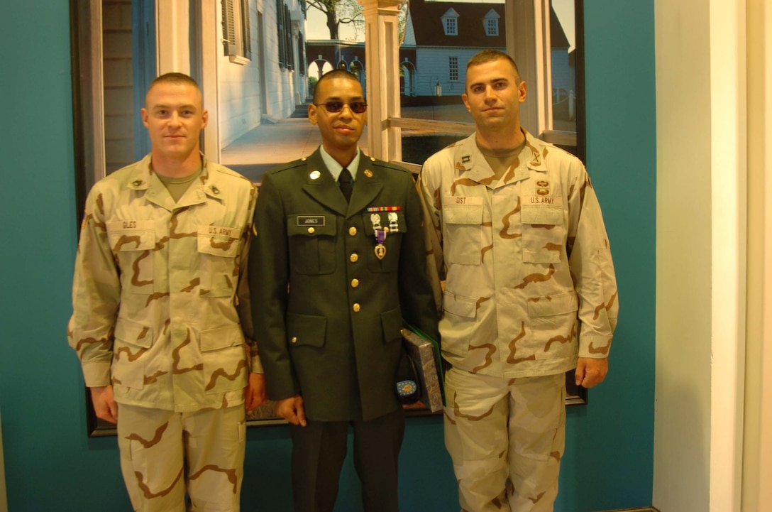 Staff Sgt. Andrew Giles and Capt. Ryan Gist stand along with Pfc. Randy Jones after Jones was presented a Purple Heart for wounds suffered in Iraq by Marine Gen. Peter Pace, chairman of the Joint Chiefs of Staff, at Mount Vernon, Va., Oct. 11. The three soldiers are from B Battery, 2nd Brigade, 8th Field Artillery, Fort Lewis, Wash. Photo by Tech. Sgt. Sean P. Houlihan, USAF