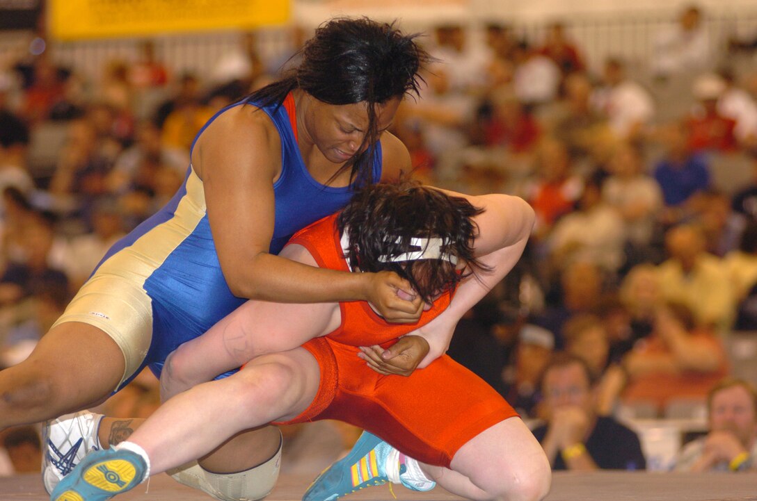 Army Sgt. Iris Smith (top), seen here defeating Ali Bernard for the 2005 women's 158.5-pound freestyle national championship at Las Vegas, won a world wrestling championship in her weight class Sept. 30 at Budapest, Hungary. Smith, a member of the U.S. Army World Class Athlete Program, is stationed at Fort Carson, Colo. Photo by Tim Hipps