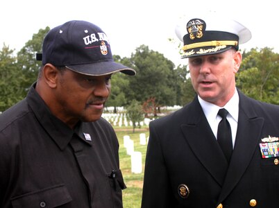 Navy Capt. Christopher W. Grady (right), former commander of the USS Cole, chats with retired Navy Chief Petty Officer Louge Gunn, whose son, Seaman Cherone L. Gunn, was killed in the Oct. 12, 2000, terrorist attack on the Cole. Grady was the keynote speaker during the White House Commission on Remembrance's fifth anniversary tribute to those who died on board the Cole. Photo by Rudi Williams