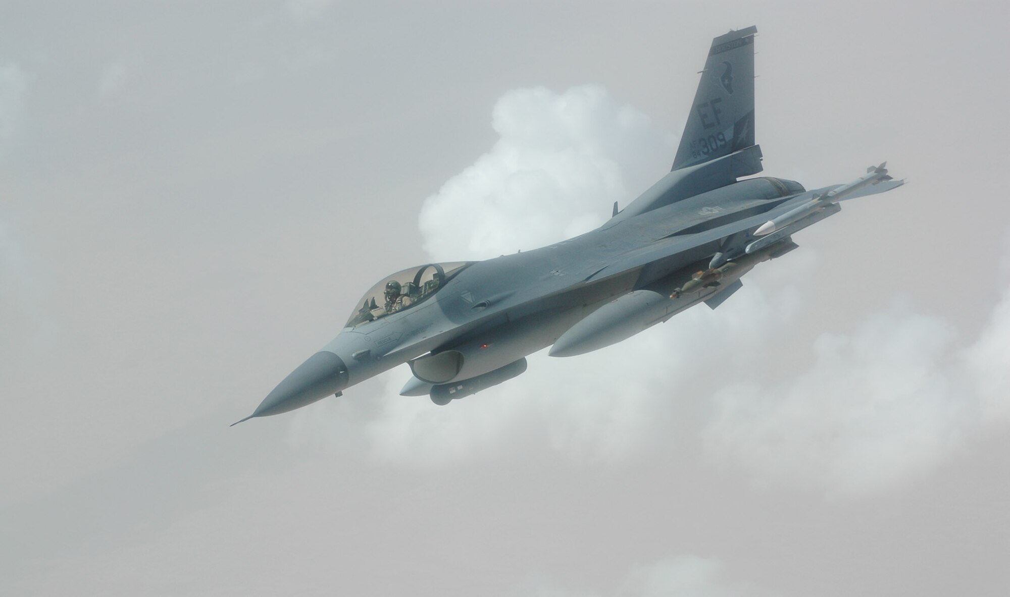 An Air Force F-16 Fighting Falcon descends through the sky over the area of responsibility.    F-16s fly close-air-support sorties in support of Operation Iraqi Freedom.  On June 30, there were 73 close-air-support missions flown.  (U.S. Air Force photo)

