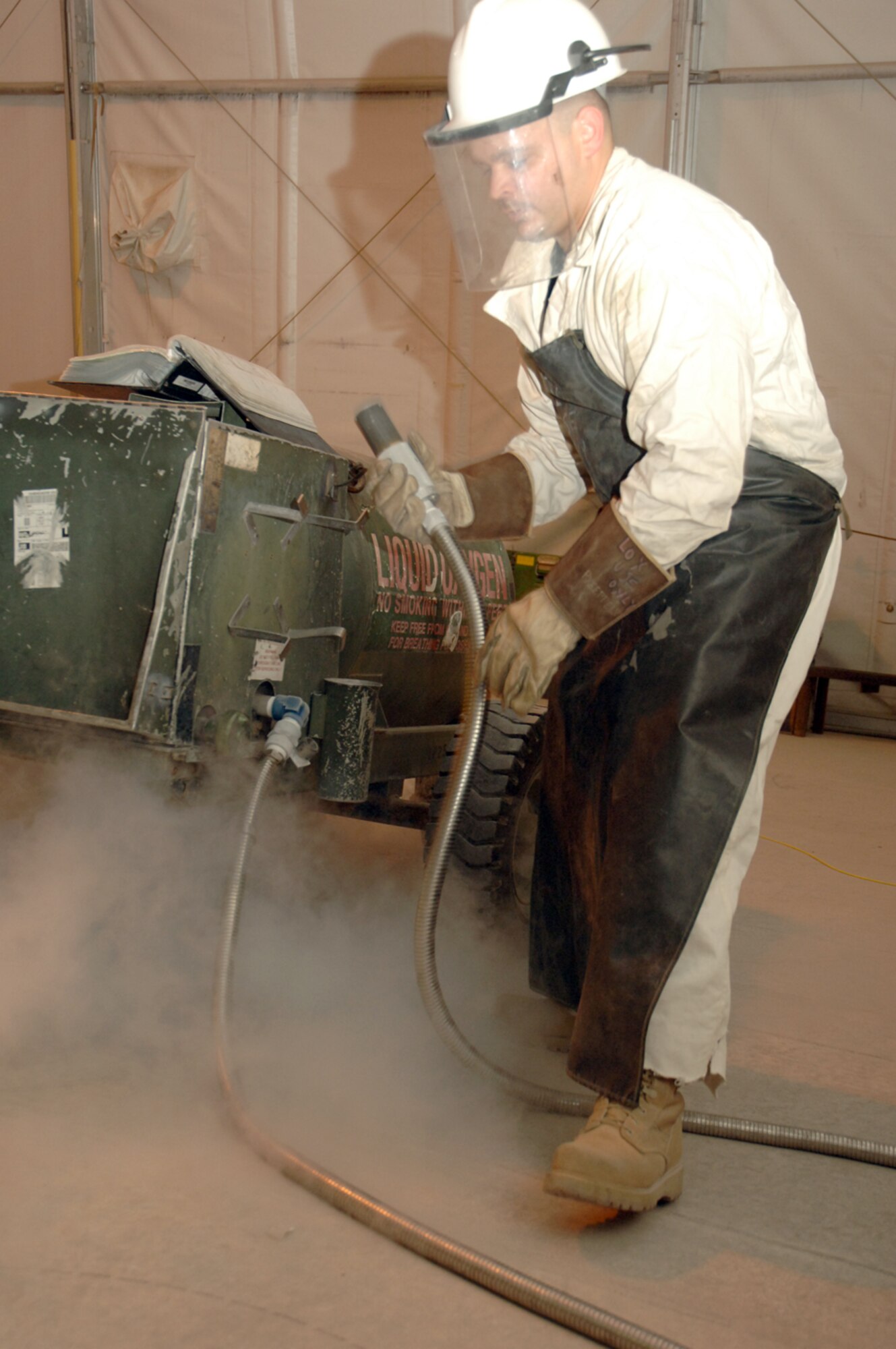 An Airman from the 379th Expeditionary Maintenance Squadron prepares liquid oxygen equipment. LOX has a variety of uses here, including breathing and fire-surpression systems, aircraft struts and tires, and several medical applications. (U.S. Air Force photo by Master Sgt. Ken Stephens) 