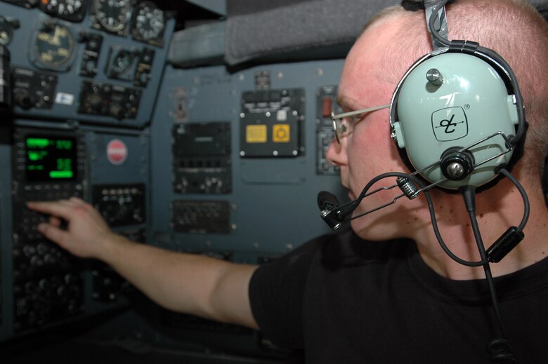 Staff Sgt. Nathaniel Nernberger, 379th Expeditionary Aircraft Maintenance Squadron, makes a radio call on a C-130 Hercules navigation computer. Sergeant Nernberger has deployed six times to locations including the 379th AEW, Kuwait and Uzbekistan.  (U.S. Air Force by Senior Airman Clark Staehle)