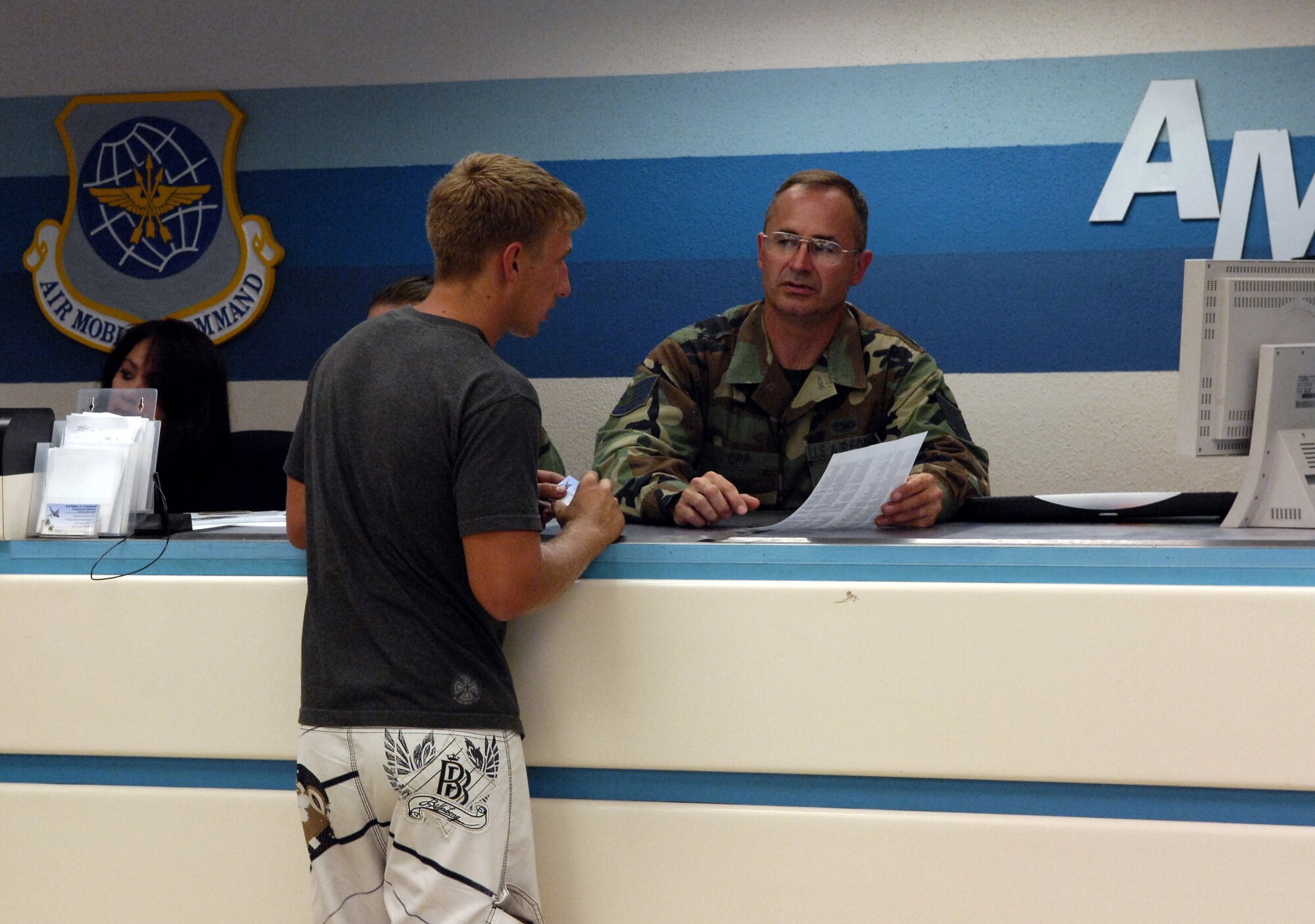 HICKAM AIR FORCE BASE, Hawaii -- Tech. Sgt. Timothy Opp helps a passenger in the passenger terminal center here. Reservists from the 87th Aerial Port Squadron, 445th Airlift Wing, Wright-Patterson Air Force Base, Ohio are conducting their two-week duty with the 735th Air Mobility Squadron. (U.S. Air Force photo/ Tech. Sgt. Shane A. Cuomo)