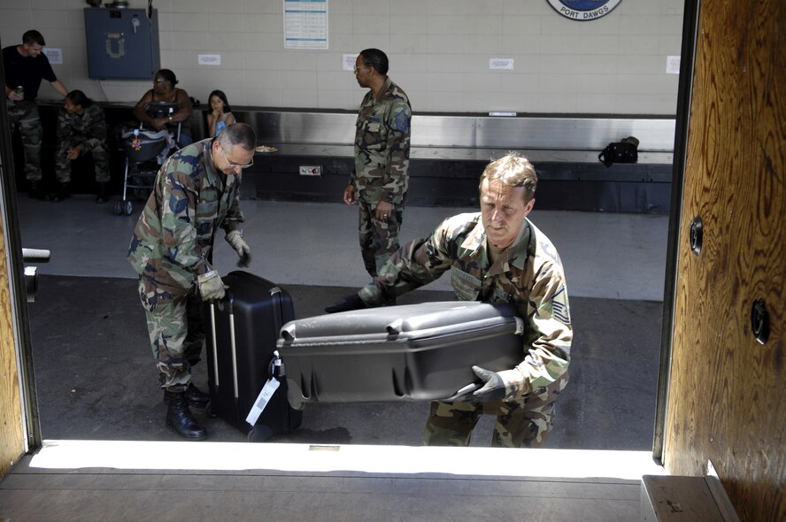 HICKAM AIR FORCE BASE, Hawaii -- Air transportation specialists load suitcases on a van July 2, 2007 at the passenger terminal center here. Reservist from the 87th Aerial Port Squadron, 445th Airlift Wing, Wright-Patterson Air Force Base, Ohio are conducting their two-week duty with the 735th Air Mobility Squadron. (U.S. Air Force photo/ Tech. Sgt. Shane A. Cuomo)