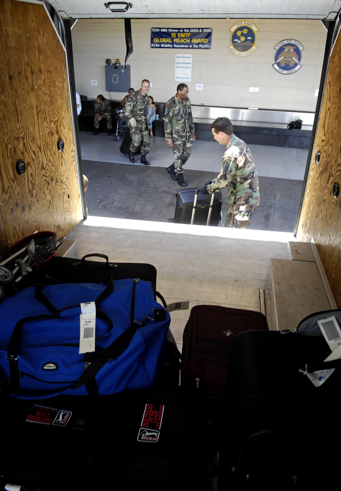 HICKAM AIR FORCE BASE, Hawaii -- Air transportation specialists load suitcases on a van July 2, 2007 at the passenger terminal center here. Reservist from the 87th Aerial Port Squadron, 445th Airlift Wing, Wright-Patterson Air Force Base, Ohio are conducting their two-week duty with the 735th Air Mobility Squadron. (U.S. Air Force photo/ Tech. Sgt. Shane A. Cuomo)