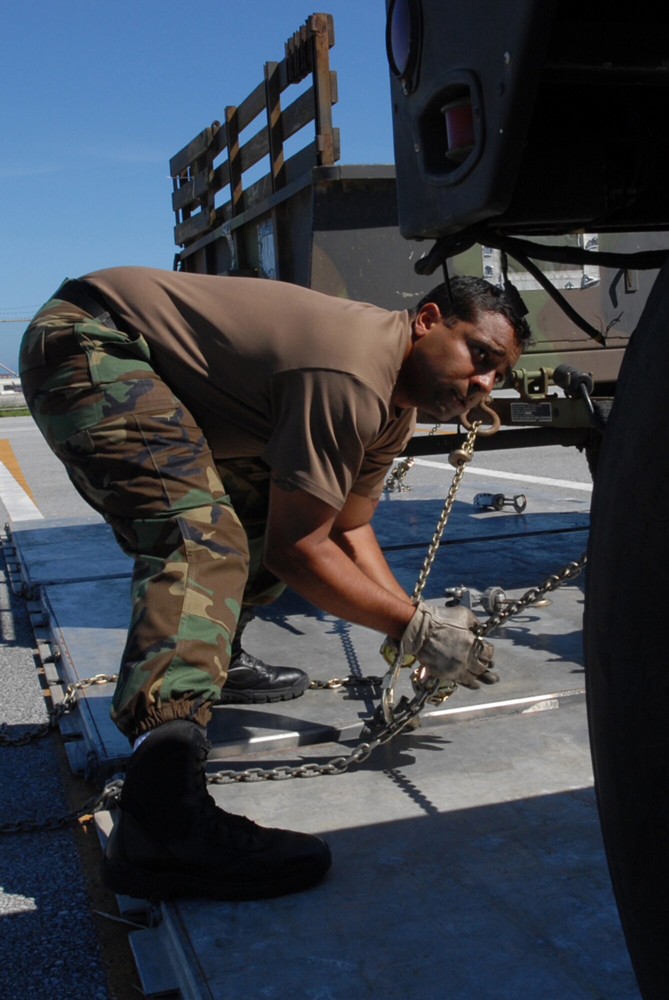 Staff Sgt. Robert Satterwhite, 733rd Air Mobility Squadron, fastens a Humvee to a pallet while training for this year’s Air Mobility Rodeo. Sergeant Satterwhite is one of six 18th Wing Airmen on the air transportation team for the event held at McChord AFB, Wash., July 22-28.
(U.S. Air Force/Airman 1st Class Kasey Zickmund)