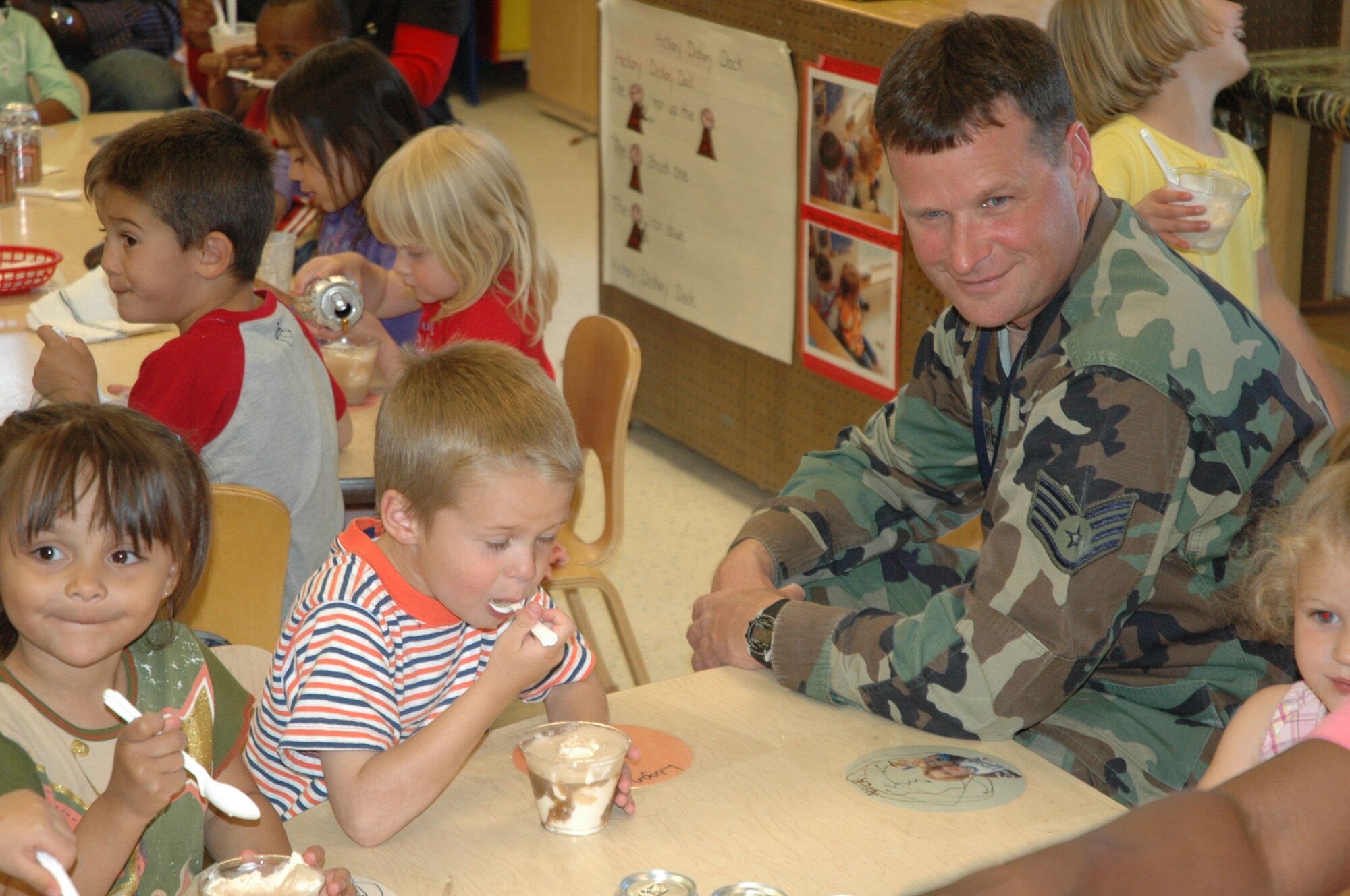 The Warren Child Development Center made root beer floats for the children as part of the parent involvement activity June 15. Staff Sgt. Les Moore, 153rd Command and Control Squadron, spends time with his son, Logan Moore, as he enjoys a float in celebration of Father’s Day (Photo by Airman 1st Class Daryl Knee).