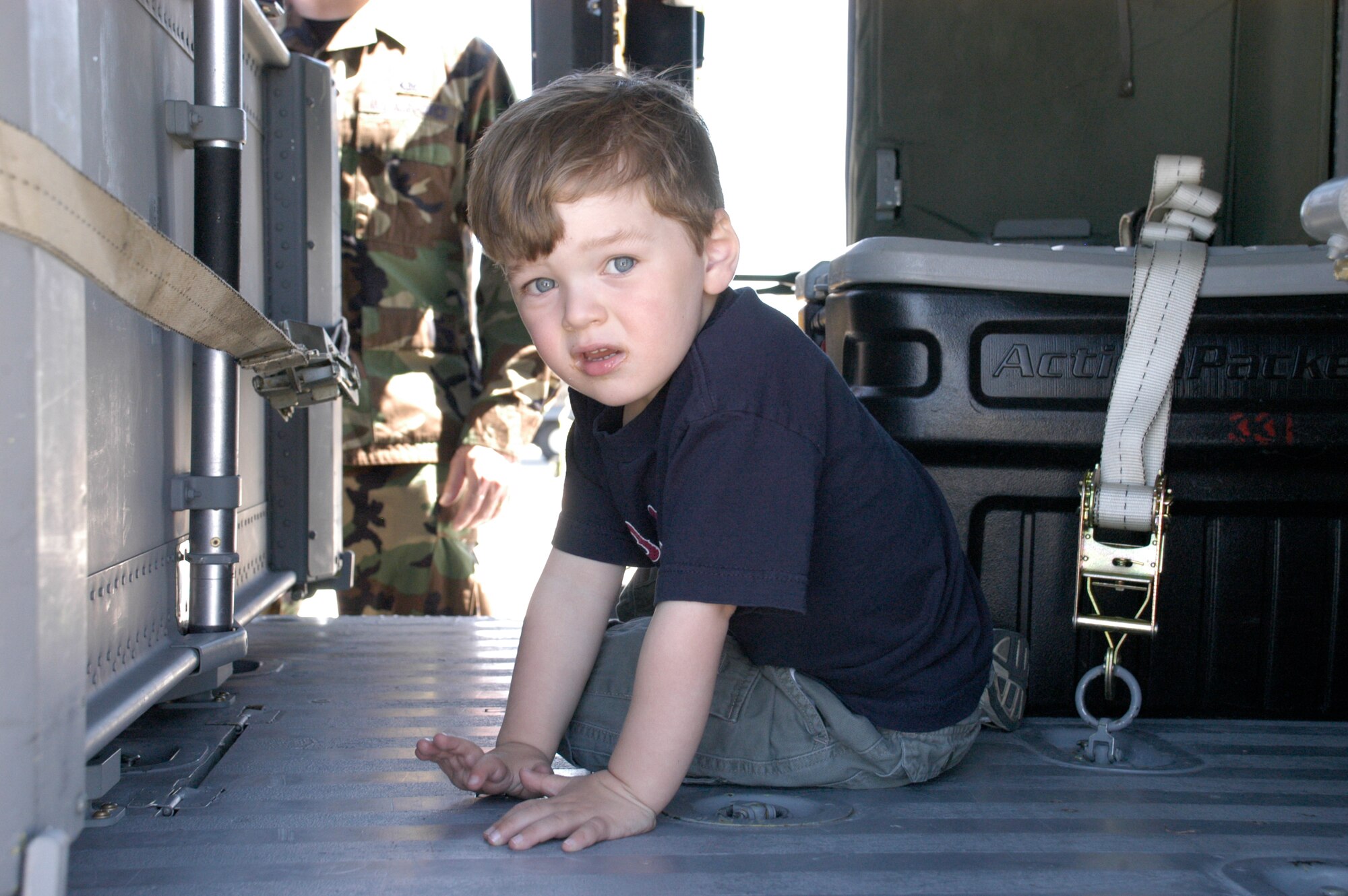 Ryan Gorman closely examines an Army National Guard UH-60 Blackhawk helicopter at the Cheyenne Regional Airport June 23. The children were bused to the Guard portion of the airport to experience the transportation aspect of deployment (Photo by 2nd Lt. Lisa Meiman).