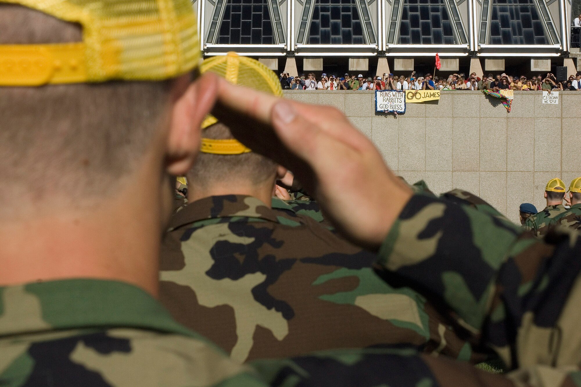 Basic cadets salute prior to being administered the oath during the swearing-in ceremony as friends and family cheer on their loved ones June 29 at the U.S. Air Force Academy in Colorado. This ceremony marks the beginning of the first half of basic cadet training, commonly known as "First Beast." (U.S. Air Force photo/Joel Strayer)
