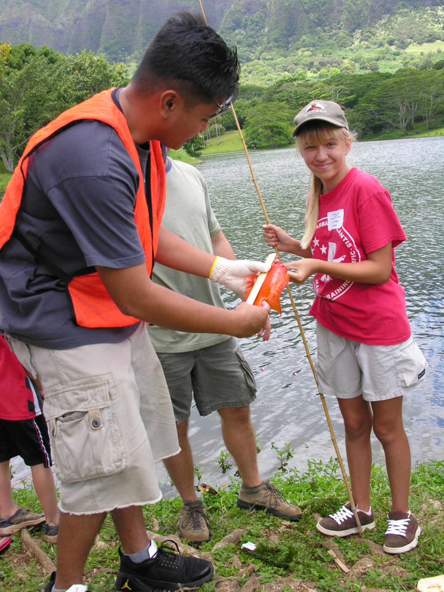 Senior Airman Don Dale, 56th Air Communications Squadron, fishing martial, measures and logs Nicole Gerboc’s fish during the tournament. More than 15 volunteers from Hickam spent the day helping with the tournament.