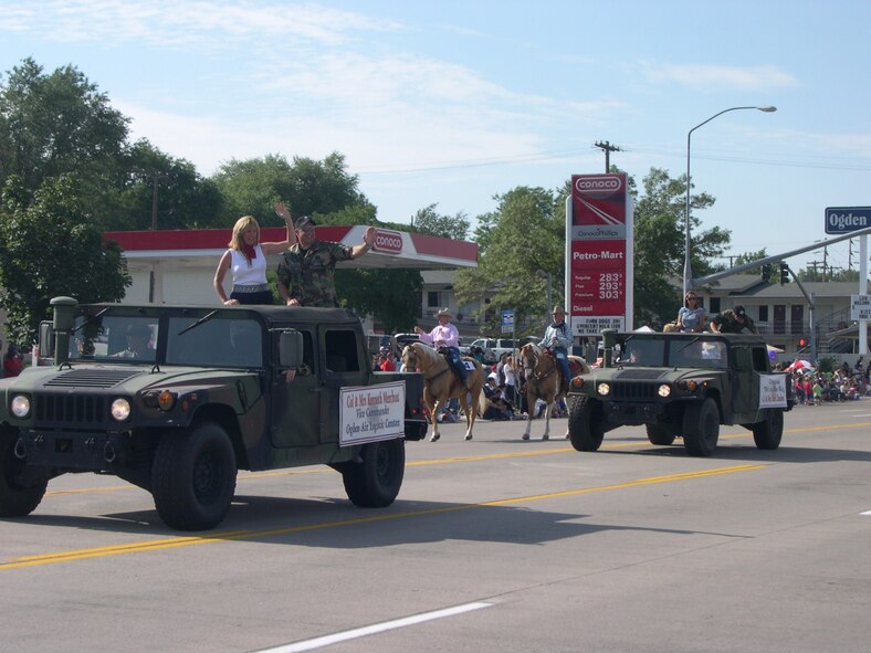 HILL AIR FORCE BASE, Utah--Senior leaders (front) Col. Kenneth Merchant, Ogden Air Logistics Center vice commander and his wife Sue and (rear) Col. Scott Chambers, 75th Air Base Wing commander, and his wife Suzann participate in the 2006 Ogden parade during the summer months.  This is an example of the many things that senior leaders and the Team Hill Ambassadors can participate in.