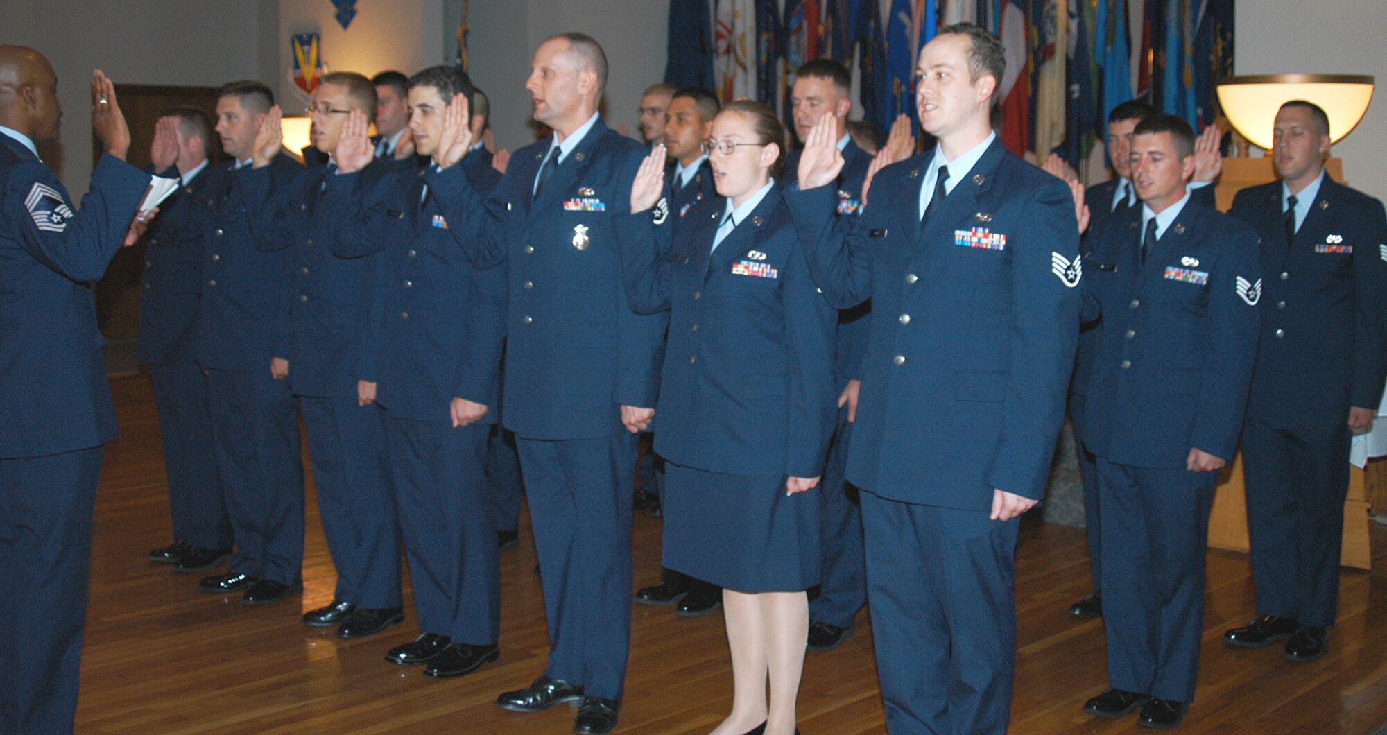 Chief Master Sgt. Randolph Bass, 7th Operations Group, administers the noncommissioned officers' charge to Dyess' newest staff sergeants at a wing induction ceremony June 29. (U.S. Air Force photo/Senior Airman Joel Mease)