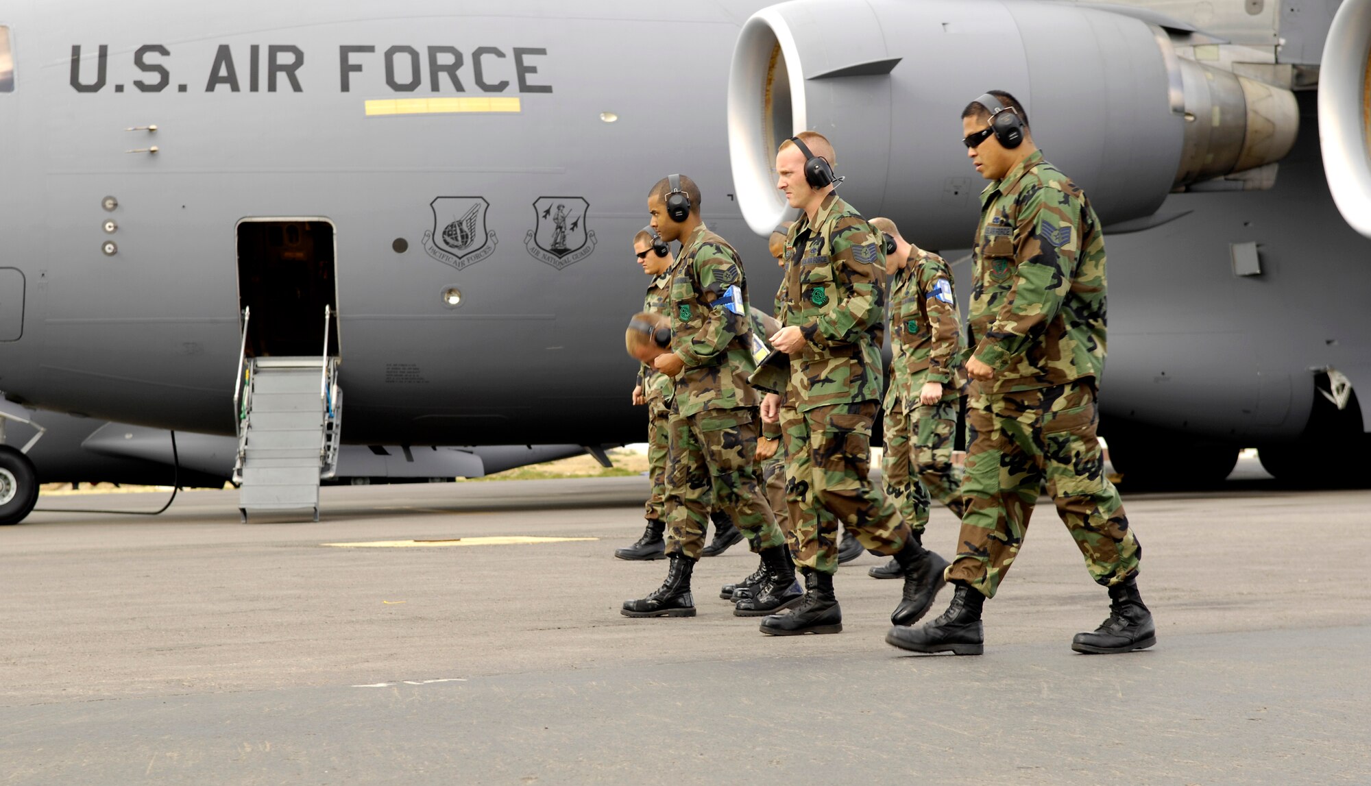 Members of the 15th Aircraft Maintenance Squadron perform a Foreign Object Debris walk prior to launching a C-17 Globemaster III. They are practicing for the Air Mobility Command rodeo at McChord AFB, Wash. Photo by Senior Airman Erin Smith
