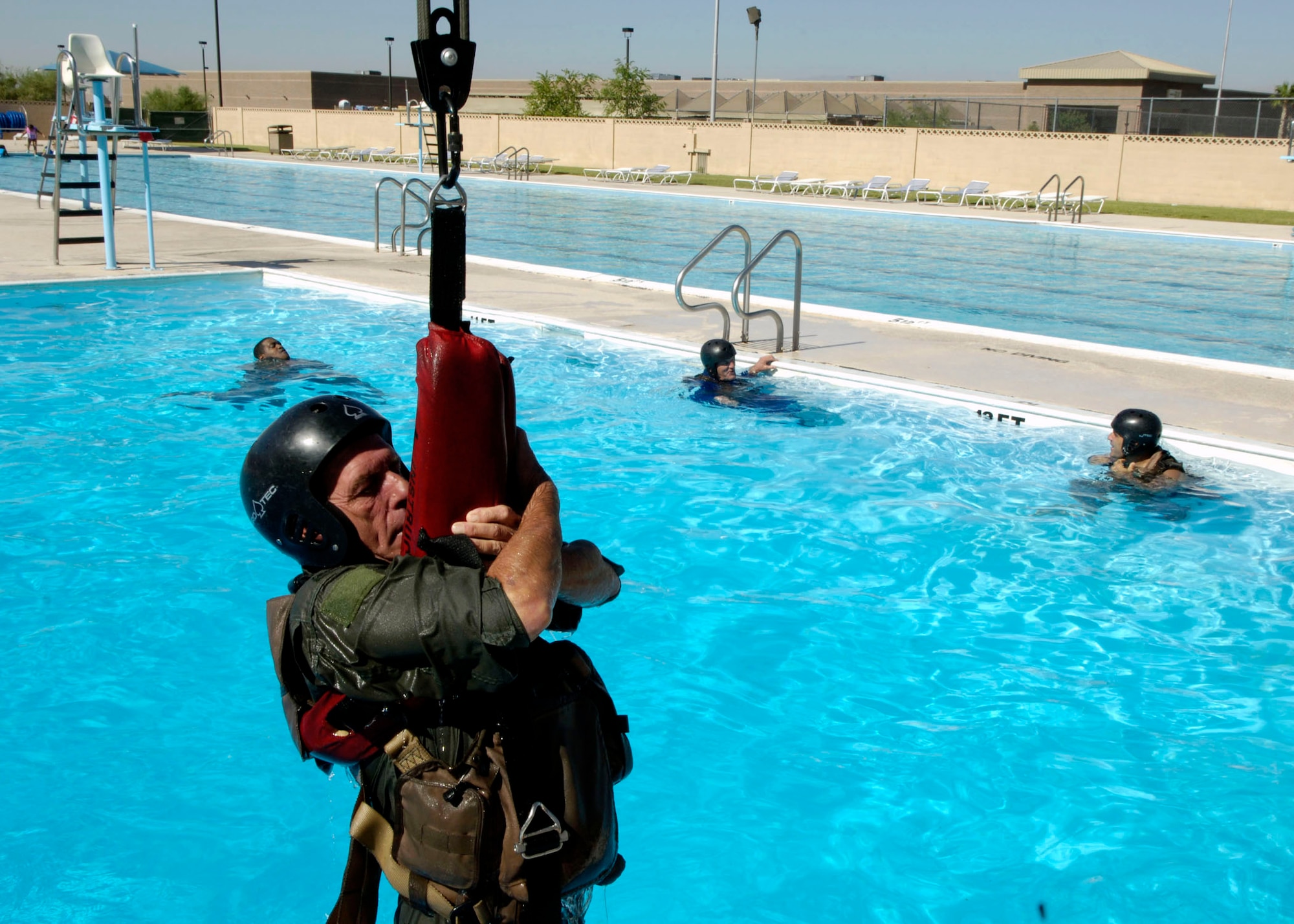 Army Chief Warrant Officer Ron Stone is hoisted to a pool platform during a simulated helicopter rescue.  The water survival training was being conducted by Air Force survival, evasion, resistance and escape, or SERE, instructors at Nellis Air Force Base, Nev.  The Army National Guardsmen, an OH-58 maintenance officer, was taking his annual water survival training.  (U.S. Air Force photo/Master Sgt. Kevin J. Gruenwald)