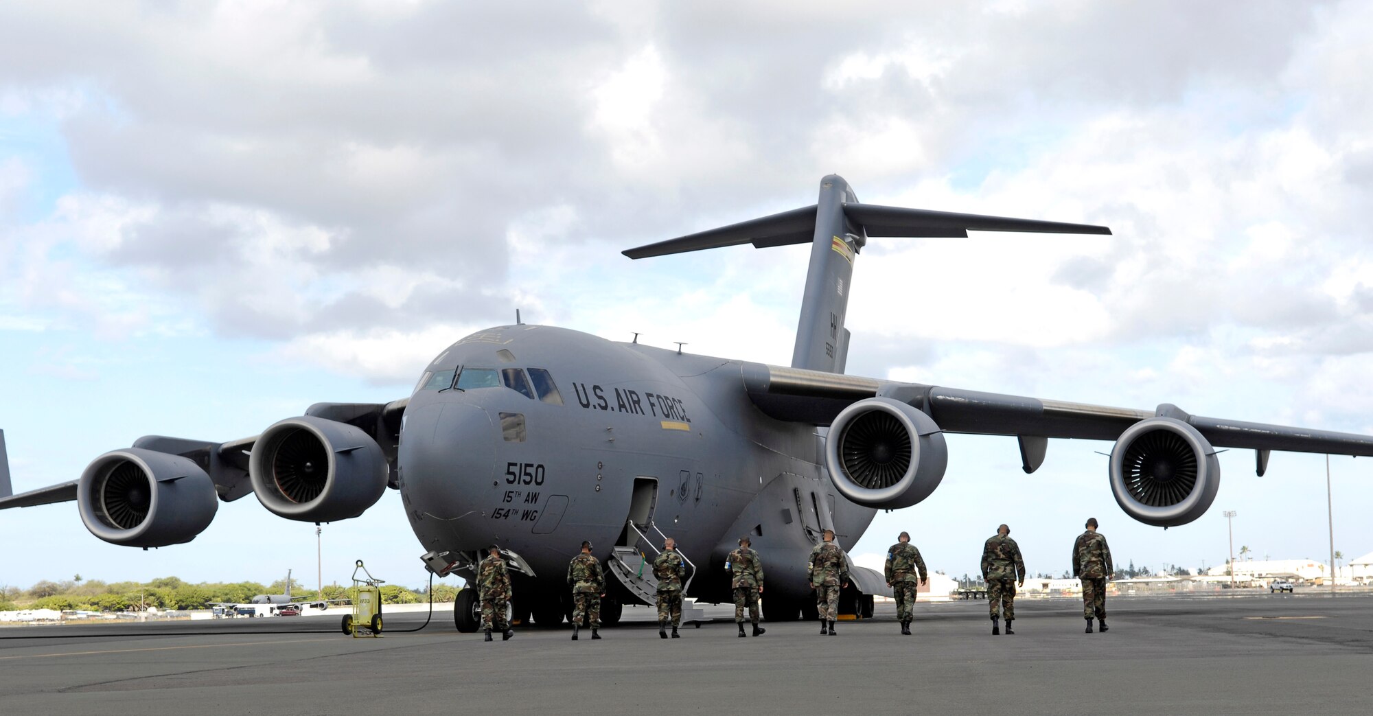 Members of the 15th Aircraft Maintenance Squadron perform a Foreign Object Debris (FOD) walk prior to launching a C-17 Globemaster III. They are practicing for the Air Mobility Command rodeo at McChord AFB, Wash. Photo by Senior Airman Erin Smith