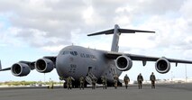 Members of the 15th Aircraft Maintenance Squadron perform a Foreign Object Debris (FOD) walk prior to launching a C-17 Globemaster III. They are practicing for the Air Mobility Command rodeo at McChord AFB, Wash. Photo by Senior Airman Erin Smith