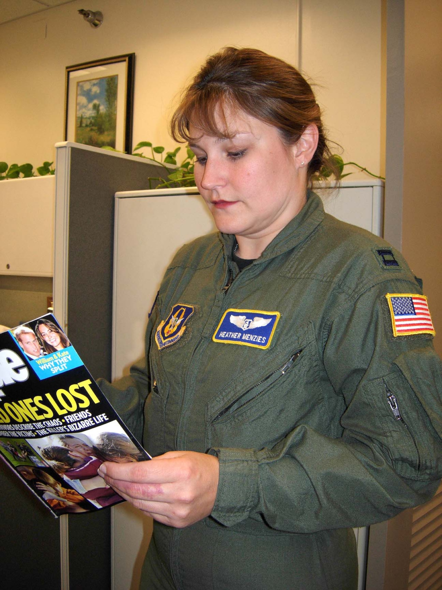 ANDREWS AIR FORCE BASE, Md. -- Capt. Heather Menzies, 459th Aeromedical Evacuation Squadron flight nurse, reads an article in People magazine May 6. The magazine featured a photo of her preparing a patient for transport from one hospital to another for further care. (U.S. Air Force photo/Staff Sgt. Amaani Lyle)