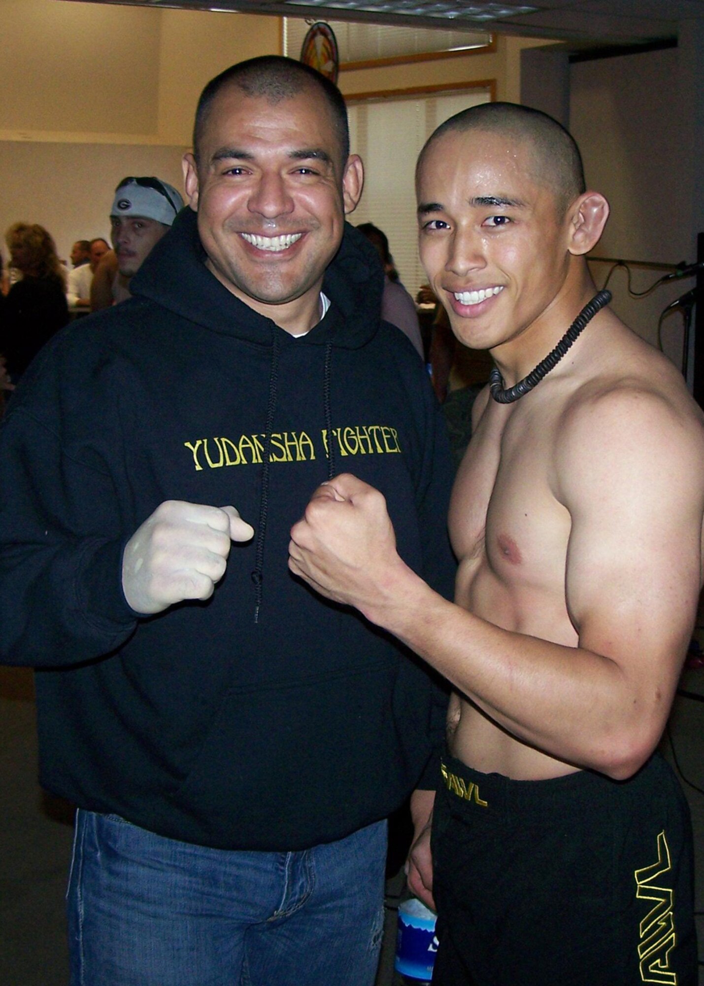 EIELSON AIR FORCE BASE, Alaska--Rico Respicio and instructor Martin Suarez pose for a victory shot after Respicio won his first victory June 22.  Respicio, an Airman with the 354th MXS, defeated his opponent, Justin Thomerson, in only 45 seconds.  (courtesy photo)

