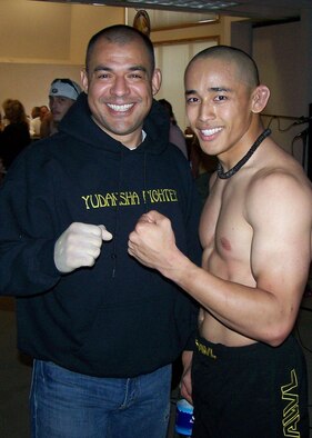 EIELSON AIR FORCE BASE, Alaska--Rico Respicio and instructor Martin Suarez pose for a victory shot after Respicio won his first victory June 22.  Respicio, an Airman with the 354th MXS, defeated his opponent, Justin Thomerson, in only 45 seconds.  (courtesy photo)

