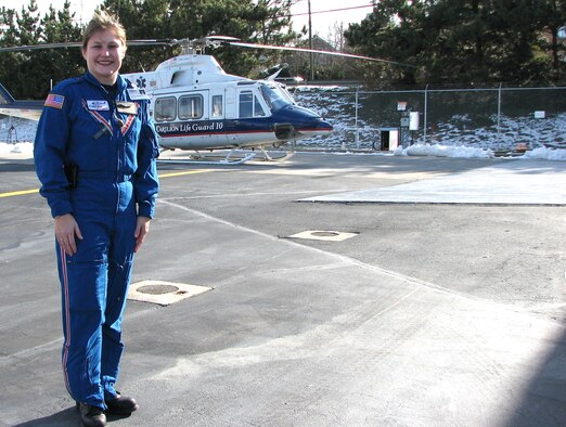 ROANOKE, Va. -- Capt. Heather Menzies, 459th Aeromedical Evacuation Squadron flight nurse, stands in front of a Carilion Life Guard 10 helicopter in an undated photo. The captain is part of a specialized ground and air transport team for critical patients. (U.S. Air Force photo/Susan Smith)
