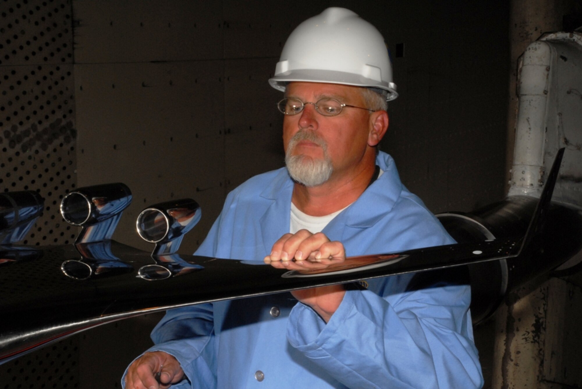 Aerospace Testing Alliance Outside Machinist Jim Lynch inspects engine nacelles on the Blended Wing Body concept test article during a model change prior to the resumption of aerodynamic testing in AEDC’s 16-foot transonic wind tunnel. (Photo by David Housch)