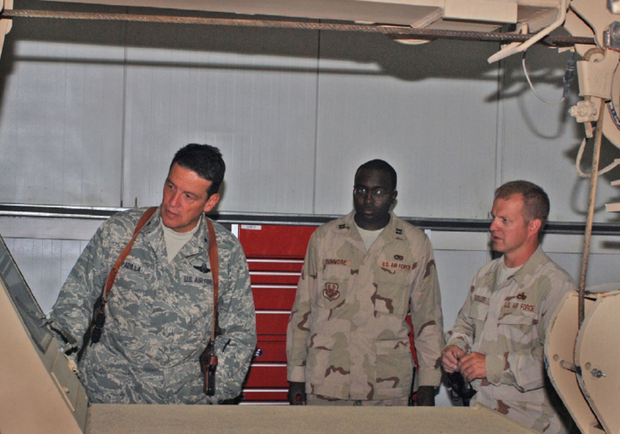 EIELSON AIR FORCE BASE, Alaska--Master Sgt. Mike Stoller explains the operation of a portable crane to Brig. Gen. Frank Padilla, CSTC-A Air Corps commander at Kabul Air Base, Afghanistan. (U.S. Air Force photo by Petty Officer First Class David Votroubek)