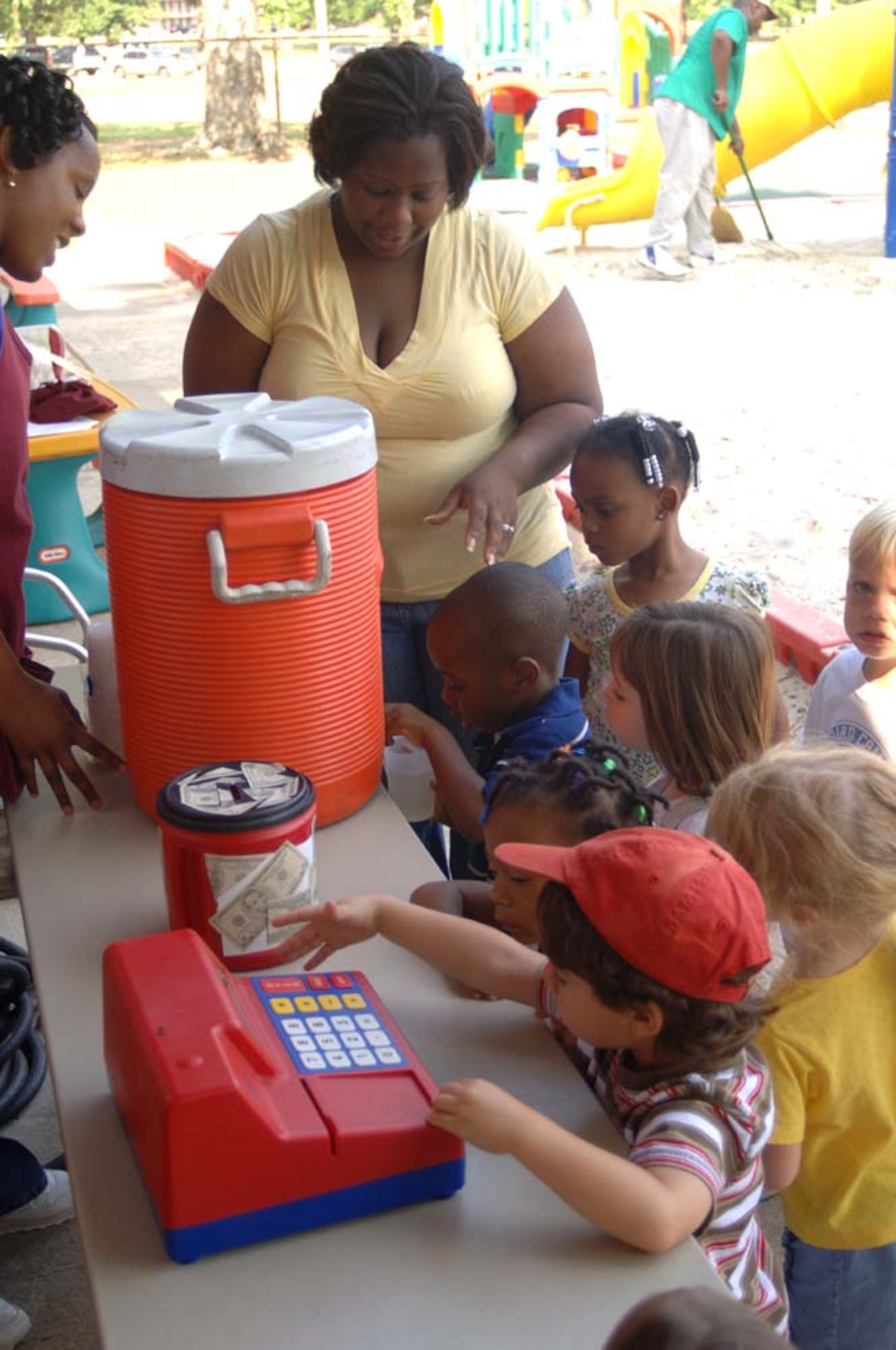 Amaron Brewer pours his mother Kisha Brewer a cup of lemonade Friday at the Child Development Center. The children in Preschool classes 1, 2 and 3 made lemonade to raise money to send phone cards to deployed troops to be able to call home. (U.S. Air Force photo by Airman 1st Class Danielle Powell)