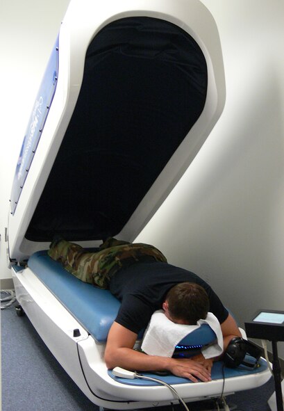 Airman 1st Class Clayton Isherwood, 723rd Maintenance Squadron electrical and environmental systems technician, relaxes after a session on the water massage table at Moody Air Force Base's Freedom I Fitness center. (U.S. Air Force photo by Kara Ramos)