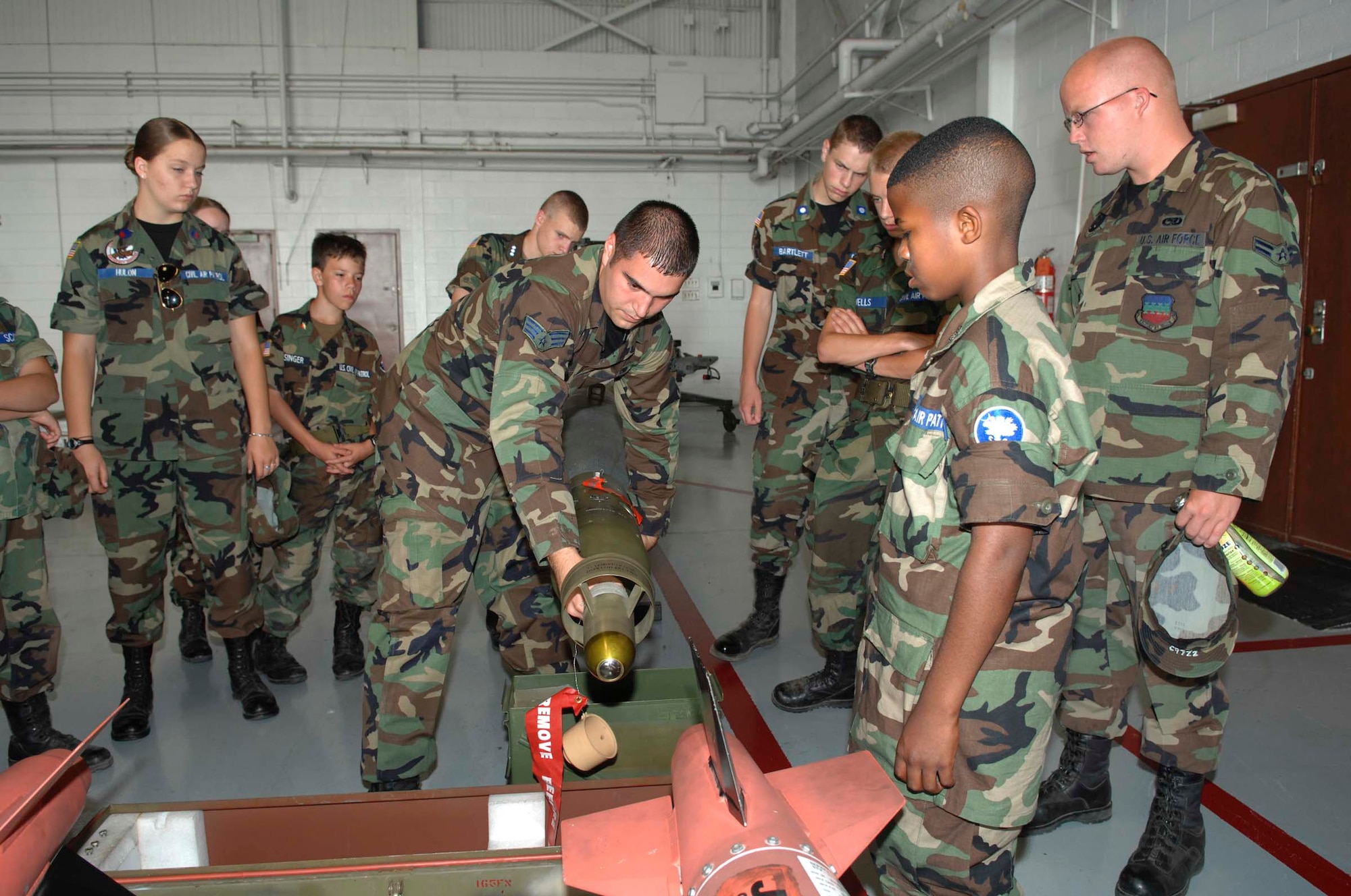 SHAW AIR FORCE BASE, S.C. -- Senior Airman Gerald Ratulowski, 20th Maintenance Operations Squadron munitions systems specialists, shows Sourth Carolina Civil Air Patrol cadets how to attach the seeker head assembly to a guided bomb unit June 27. The Civil Air Patrol is the official auxiliary of the Air Force which conducts aerospace education, cadet programs and search and rescue missions. (U.S. Air Force photo by Airman 1st Class William Coleman)