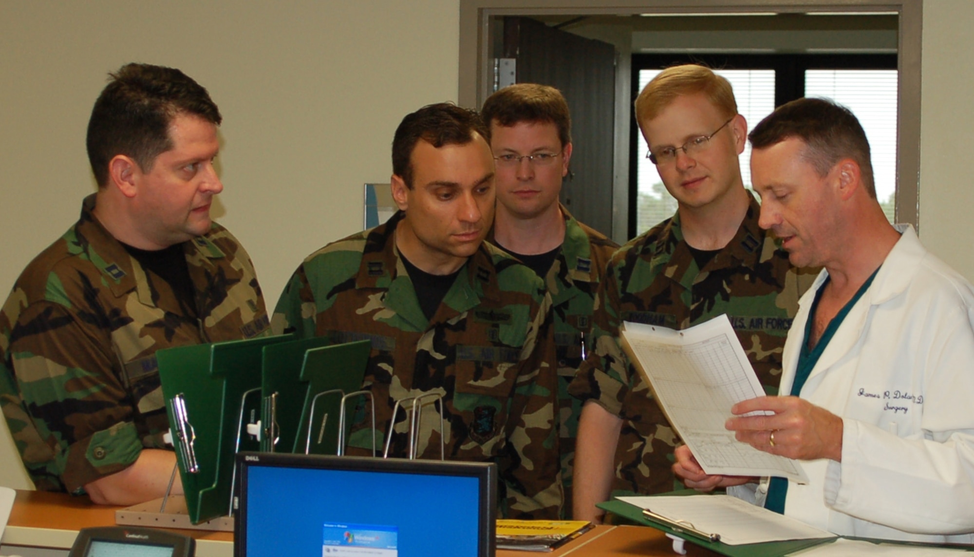 From left, Capts. (Drs.) Andrew Matthies, Joseph Lotterhos, Mark Lytle and Charles Woodham, first-year surgical residents, visit the inpatient surgery unit with Colonel Dolan during an orientation tour of the medical center June 22.  The colonel is director of the 81st Medical Group’s surgery residency program.  (U. S. Air Force photo by Steve Pivnick)