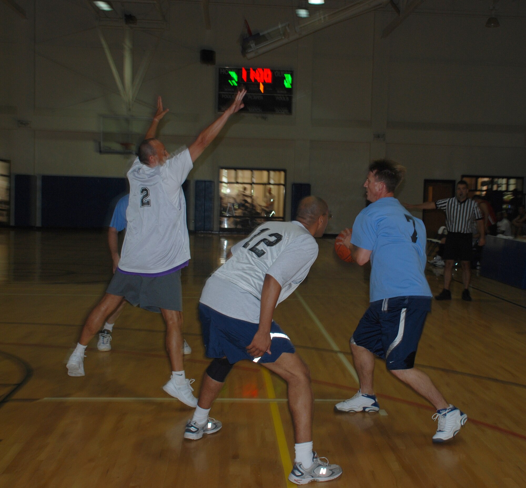 Col. Jeffrey Thompson, 82nd Dental Squadron commander, tries to pass past his opponenets during the vice commanders going away basketball tournament June 29 at the Pitsenbarger Fitness Center. Col. Lansen Conley's, 82nd Training Wing vice commander, team the Eagles, faced off against a team of Sheppard squadron commanders and a team of Sheppard senior NCO's. Coming out strong in the first game, the Eagles beat the squadron commander's team 24-23, but fell to the senior NCO's, 37-26. The Eagles never left the court between games. (U.S. Air Force photo/Airman 1st Class Jacob Corbin)