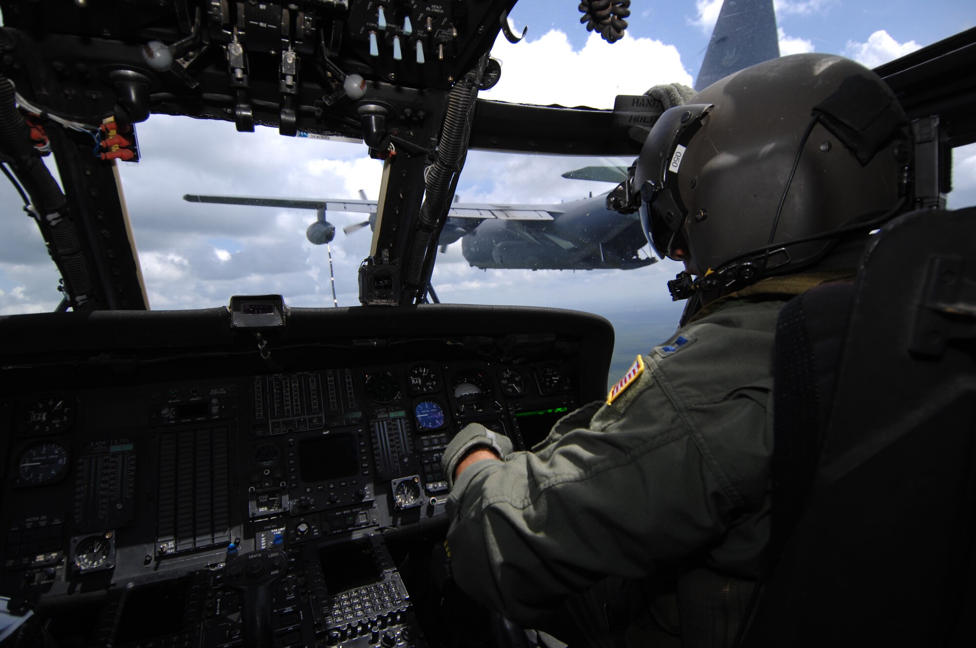 Capt. Jason Chambers, 41st Rescue Squadron HH-60G Pave Hawk mission pilot, monitors his flight instruments during an aerial refueling mission with an HC-130P assigned to the 71st RQS, June 27. A video production company visited Moody Air Force Base, Ga., to film a spot for the U.S. Air Force recruiting campaign, "Do Something Amazing." (U.S. Air Force photo by Master Sgt. Scott Reed)