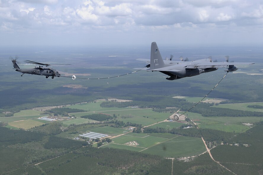 An HC-130P and an HH-60G Pave Hawk perform an aerial refueling mission June 27 in the skies over Georgia. A video production company visited Moody Air Force Base, Ga., to film a spot for the U.S. Air Force recruiting campaign, "Do Something Amazing."  The aircraft and crews are assigned to the 23rd Wing at Moody. (U.S. Air Force photo by Master Sgt. Scott Reed)