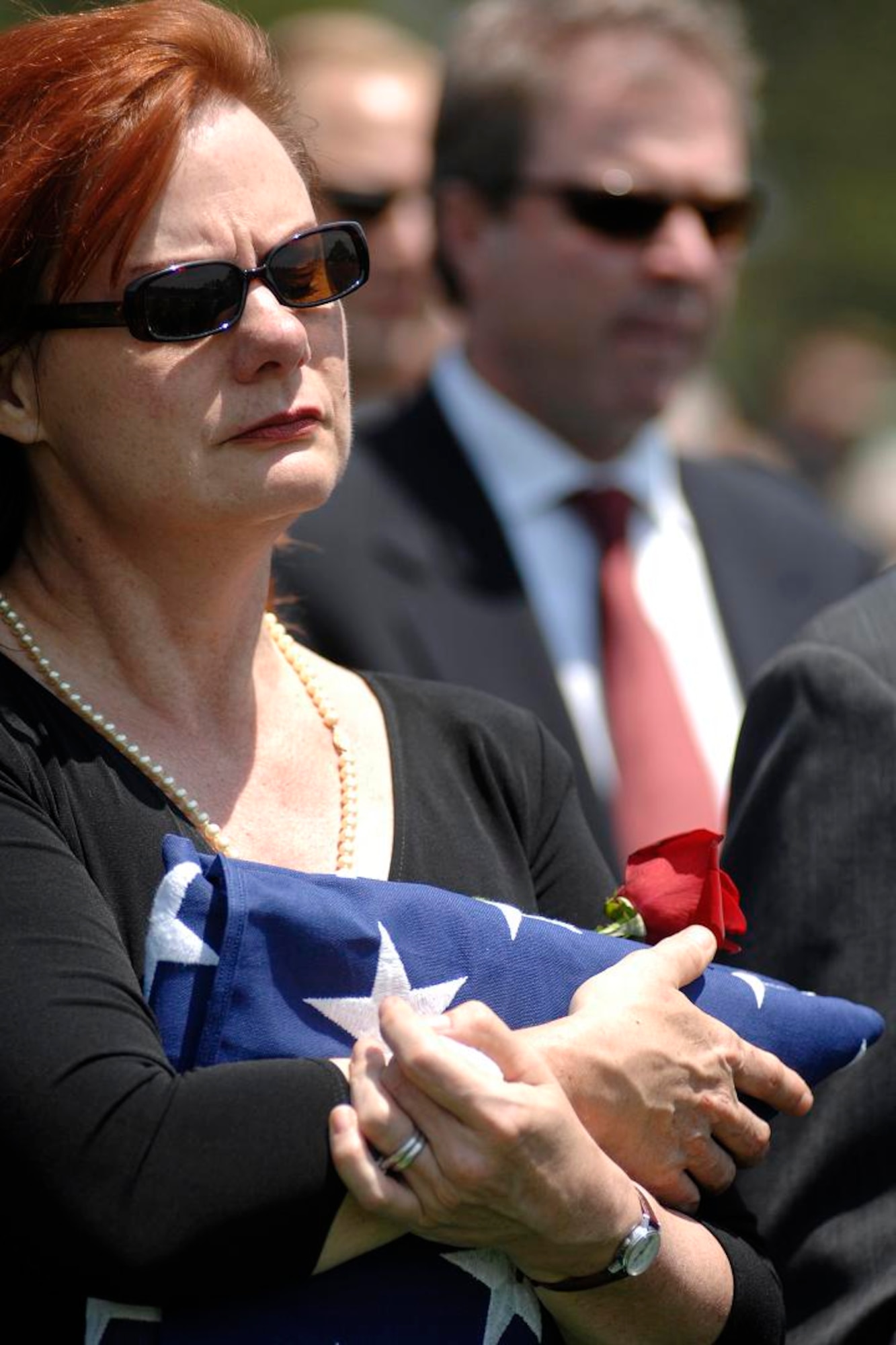 Susan Scott-Risner, daughter of retired Brig. Gen. Robin Olds, hugs the flag presented in his honor during his funeral services June 30 at the U.S. Air Force Academy in Colorado Springs, Colo.  General Olds, one of the Air Force's leading fighter pilots, died June 14 in Steamboat Springs Colorado at the age of 84.  (U.S. Air Force photo/Dennis Rogers)