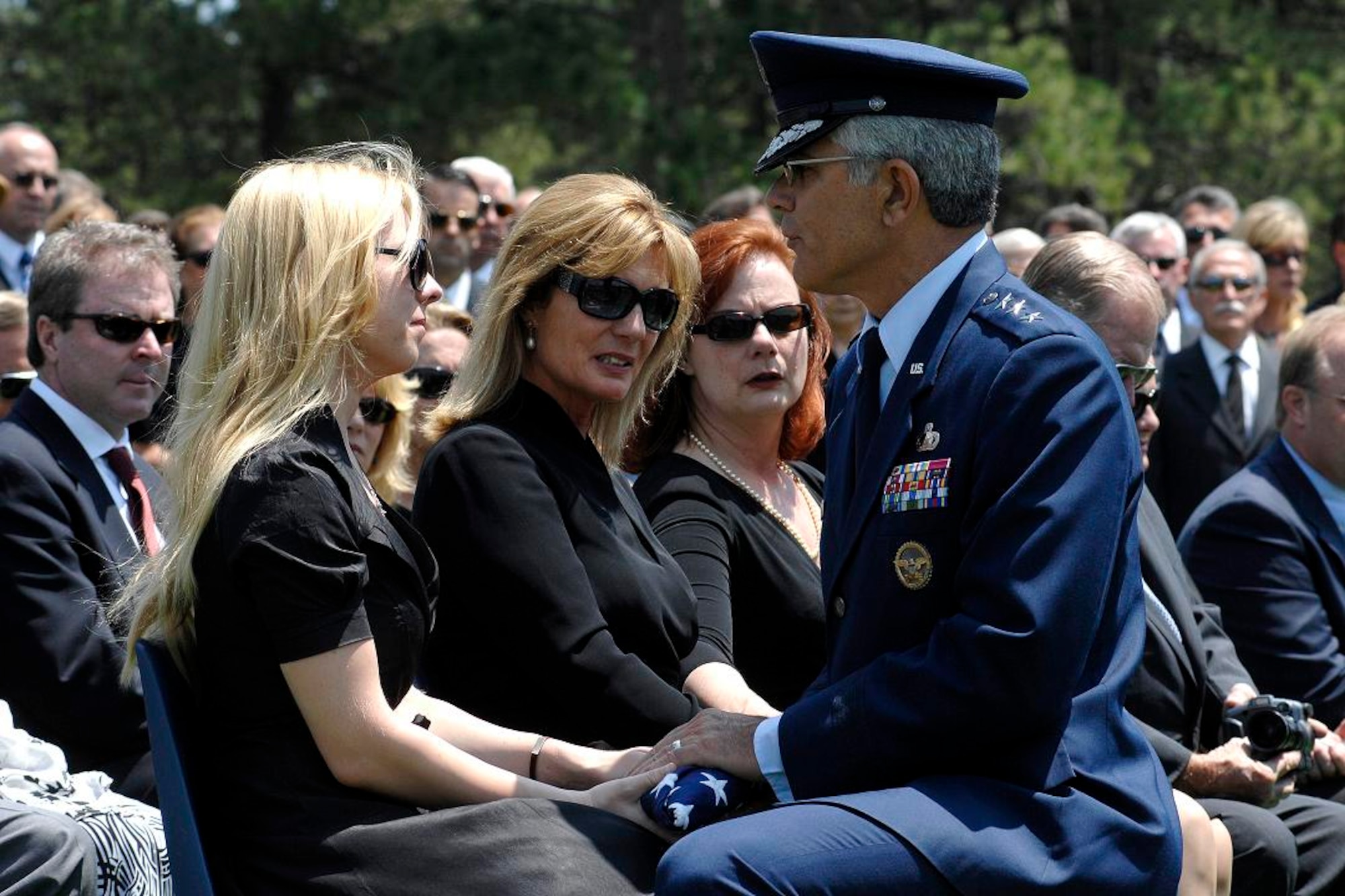 Lt. Gen. John Regni, superintendent of the U.S. Air Force Academy, presents the American flag to Jennifer Newman, granddaughter of retired Brig. Gen. Robin Olds, at his funeral ceremonies June 30. General Olds, one of the Air Force's leading fighter pilots, died June 14 in Steamboat Springs, Colo.  (U.S. Air Force photo/Dennis Rogers)