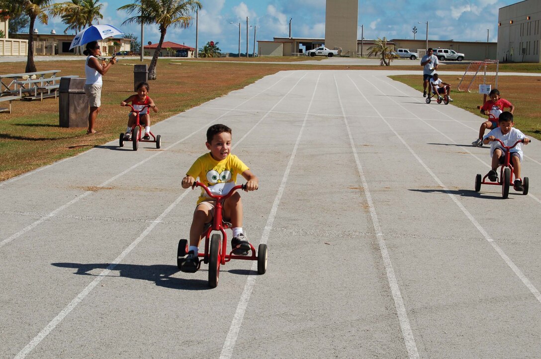 Christian Lujan leads the pack during the tricycle event during the family track day Saturday at the base track. More than 15 Team Andersen members competed in the event. (U.S. Air Force Photo/Airman 1st Class Carissa Morgan)