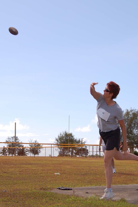 Linda Willand, a military spouse and mother of two, hurls the discus during the discuss throw. (U.S. Air Force Photo/Airman 1st Class Carissa Morgan)