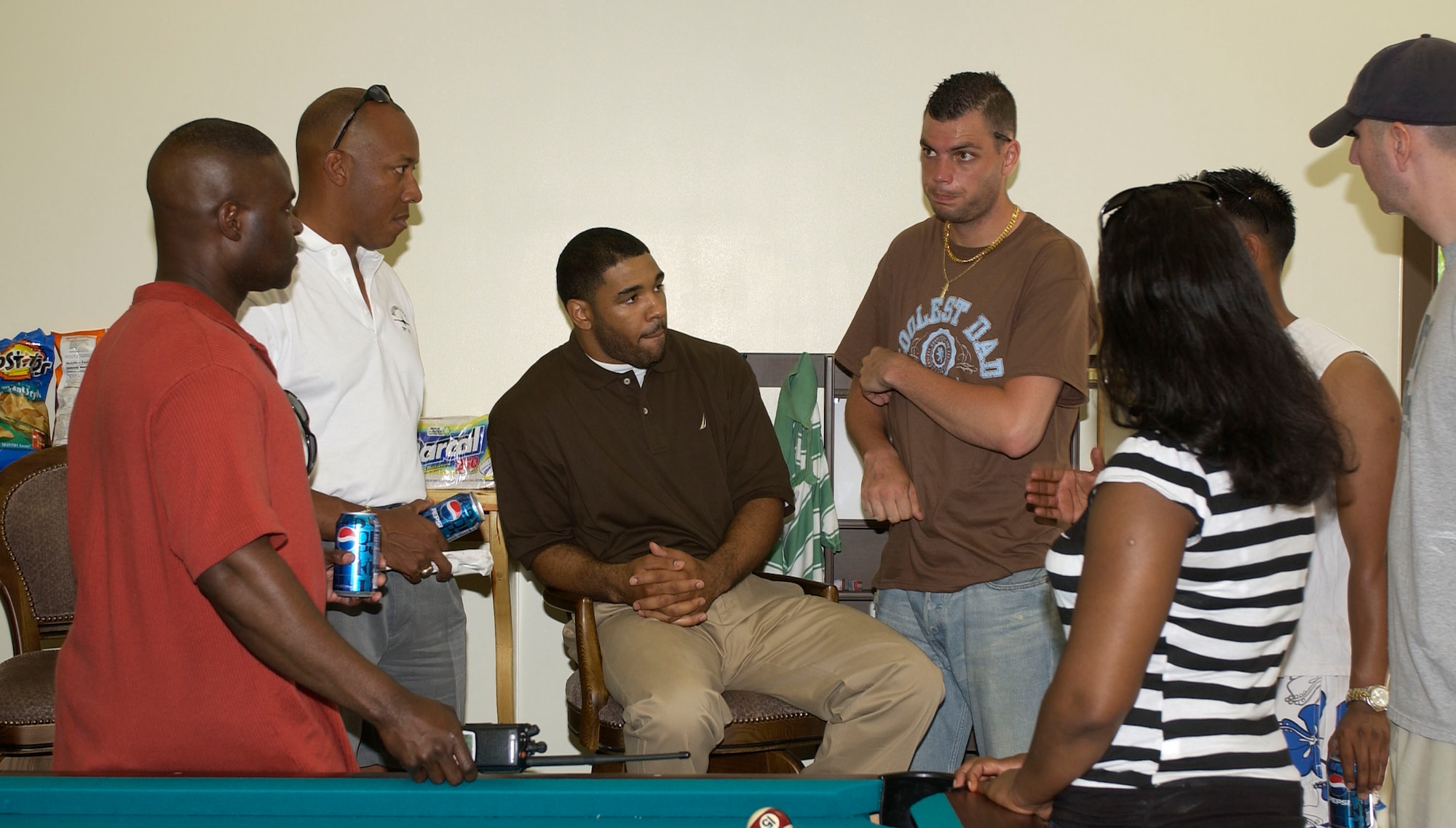 Senior Airman Steven Doty, Airmen Committed to Excellence (ACE) association president, and other ACE council members discuss issues with Col. CQ Brown, 8th Fighter Wing commander, and Chief Master Sgt Eric Harmon, acting Command Chief, during the ACE barbeque June 17 here.  The ACE sponsored the event to encourage Airmen to get involoed with the association.  (U.S. Air Force photo/Staff Sgt Darcie Ibidapo)